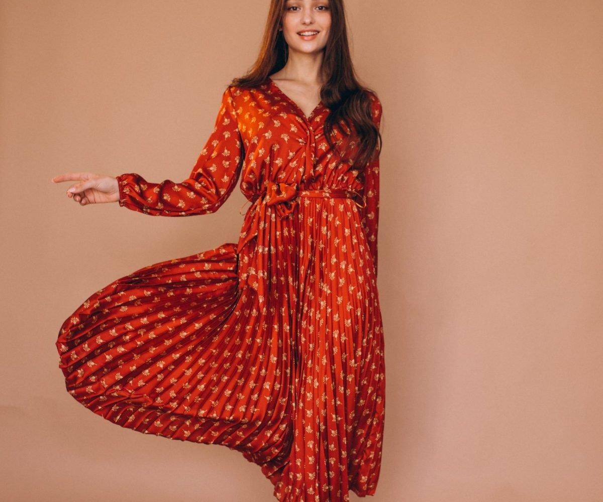 Young woman in a beautiful red dress in studio